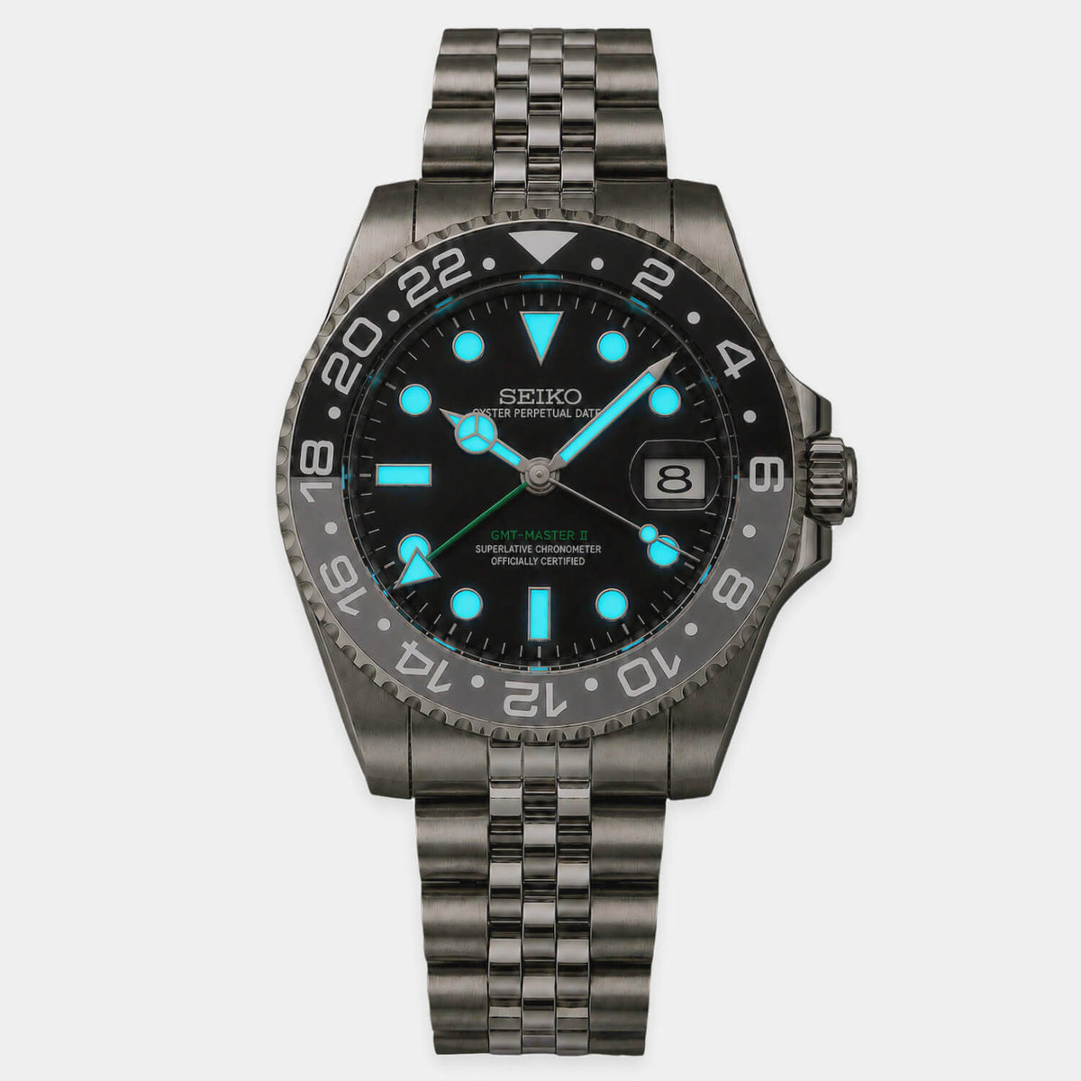 Lumed view of Seiko Bruce Wayne GMT automatic mod watch with black and gray bezel and jubilee bracelet