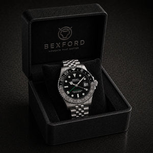 A Bexford stainless steel watch with a black dial and bezel, presented inside its black branded Bexford gift box on a dark background.