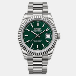 A Seiko Oyster Perpetual Datejust watch with a silver stainless steel fluted bezel and link bracelet, featuring a dark green dial with silver-tone indices and hands.
