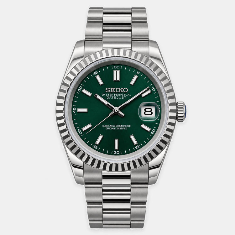 A Seiko Oyster Perpetual Datejust watch with a silver stainless steel fluted bezel and link bracelet, featuring a dark green dial with silver-tone indices and hands.
