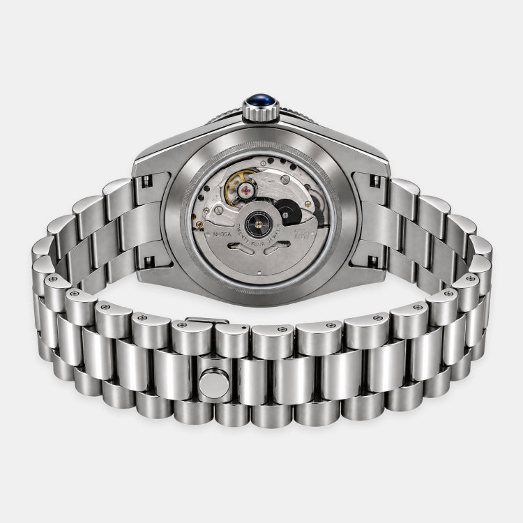 A stainless steel automatic watch shown from the back, featuring a matching metal link bracelet and a visible mechanical movement through the case back.