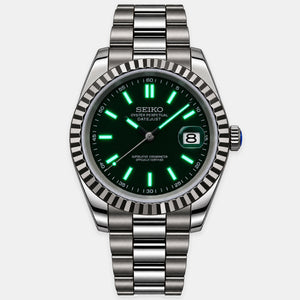A Seiko stainless steel watch with a dark green dial, bright green luminescent markers, and a fluted bezel, shown on a light gray background.