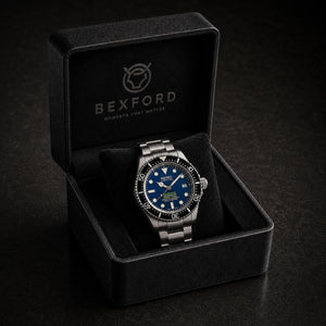 A Bexford wristwatch with a blue dial and silver stainless steel case, displayed inside an open black Bexford presentation box on a dark background.