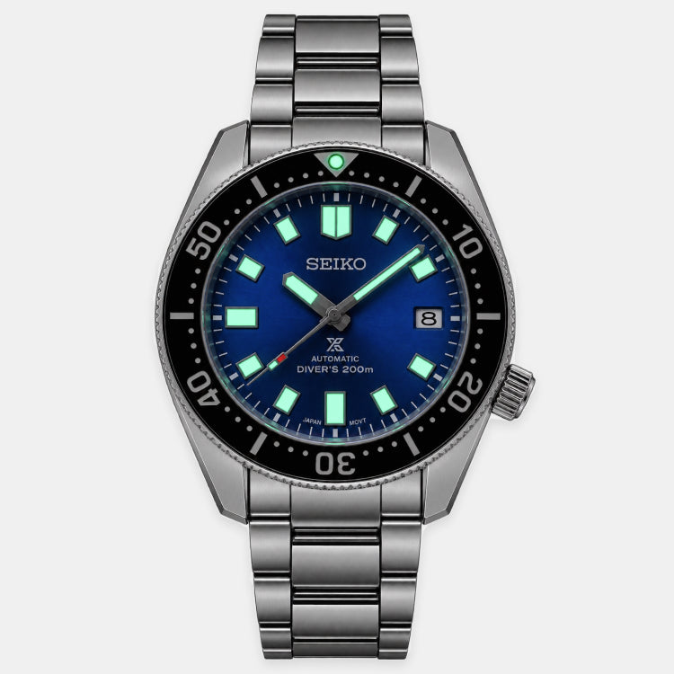 A Seiko Diver's Automatic watch with a stainless steel link bracelet, featuring a blue dial, luminous green markers, and a black rotating bezel.