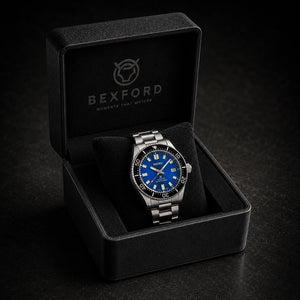 A Bexford stainless steel wristwatch with a vibrant blue dial and black bezel, presented inside its open black branded gift box on a dark textured background.